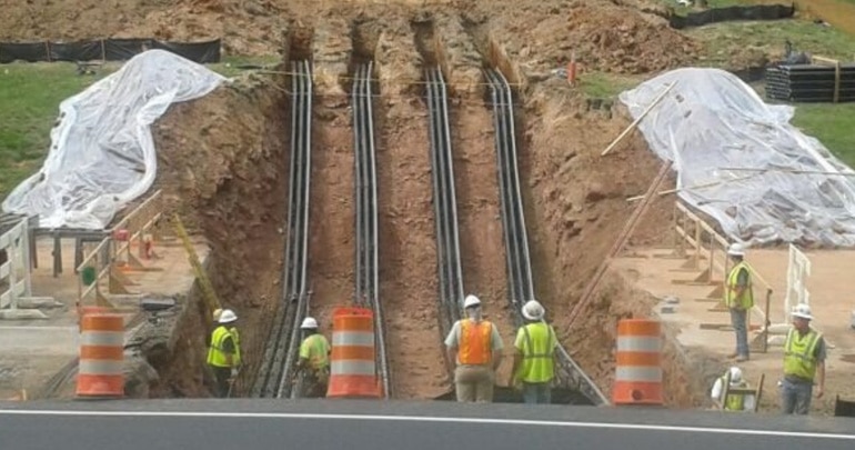 electrical conduit being buried underground