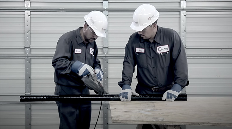 A portable bandsaw cuts fiberglass conduit